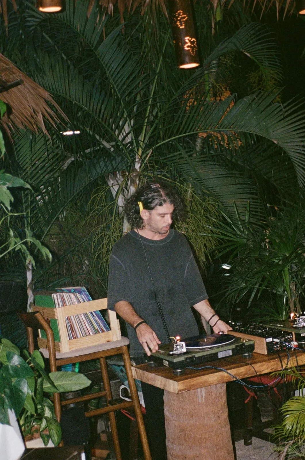 DJ OFF_GRIDD playing vinyl among the palms
