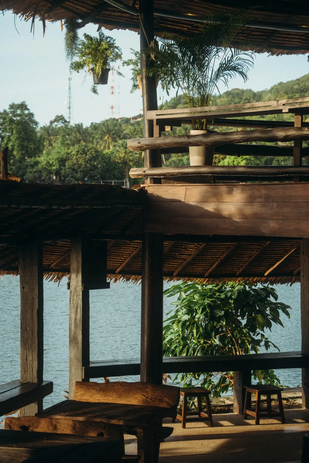 Lakeside pavilion at The Lakehouse in Koh Phangan, timber seating, palm-thatch roof and views over the lake