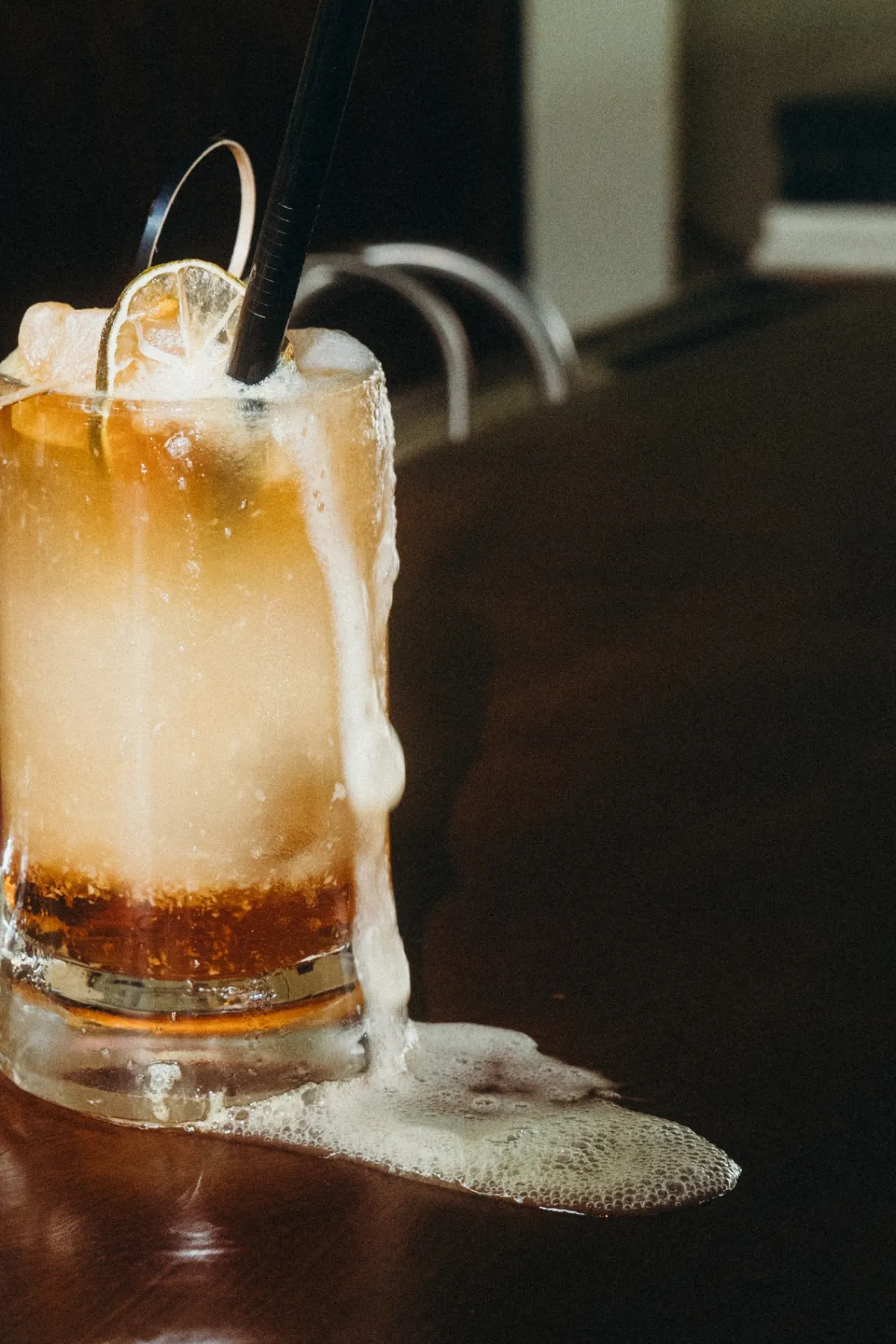 Overflowing whiskey highball cocktail on the bar at The Lakehouse